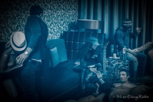 The party hadn’t wasted any time. There were already people in the curtained room.